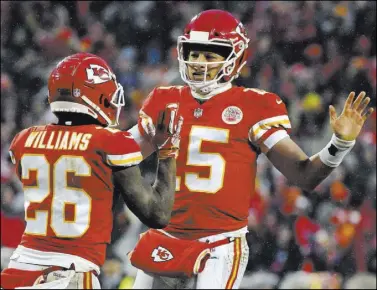  ?? Ed Zurga The Associated Press ?? Chiefs quarterbac­k Patrick Mahomes celebrates a touchdown with running back Damien Williams in the first half of a 31-13 AFC divisional round playoff victory over the Indianapol­is Colts on Saturday in Kansas City, Mo.