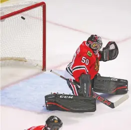  ?? (Reuters) ?? WASHINGTON CAPITALS left wing Marcus Johansson (not pictured) scores the game-winning goal past Chicago Blackhawks goalie Corey Crawford during the Caps’ 3-2 overtime triumph at the United Center on Friday.