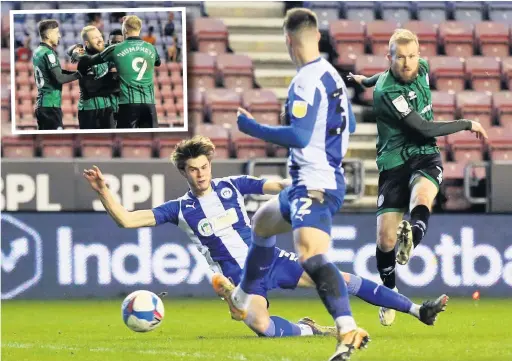  ?? Lewis Storey ?? ●●Stephen Dooley fires Dale’s third goal against Wigan at the DW Stadium and, inset, celebrates with team mates