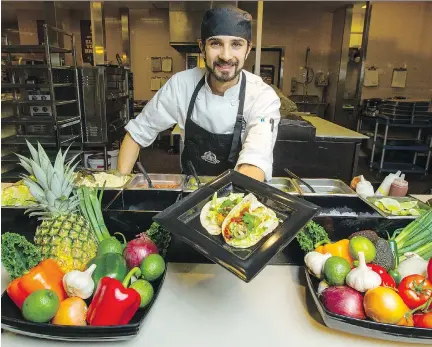  ??  DARREN BROWN/OTTAWA CITIZEN ?? Chef Neil Dhawan shows off one of his Thai blackened tilapia fish tacos at the Trainyards Farm Boy buffet bar. Dhawan is in charge of the new ‘Fresh X-Press' and serves different made-to-order lunches every day.