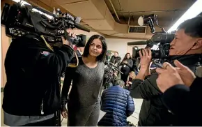  ?? AP ?? Rahaf Mohammed makes her way through a crowd of media after giving a public statement in Toronto.