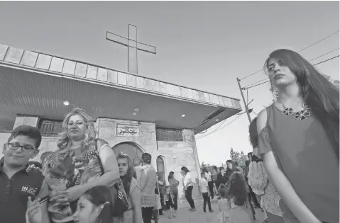  ?? PHOTOS BY SAFIN HAMED, AFP/GETTY IMAGES ?? Iraqi Christians attend a Holy Mother Mary Mass at the church of Mart Shmoni in Arbil, the capital of the autonomous Kurdish region of northern Iraq, on May 31.