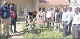  ?? (Pics: Phiwase Phungwayo) ?? The minister watering the tree after planting it at the Swaziland Conference of Churches premises. She is flanked by a delegation from her ministry, as well as that from the Ministry of Toursim and Environmen­tal Affairs.