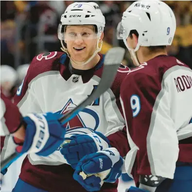  ?? MARK HUMPHREY/AP ?? Avalanche center Nathan MacKinnon leads the defending Stanley Cup champions into their title defense on Tuesday.