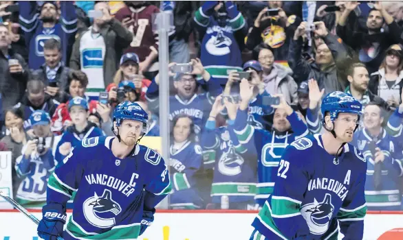  ?? DARRYL DYCK/THE CANADIAN PRESS ?? Henrik Sedin, left, and his twin brother Daniel, seen during their curtain call at Rogers Arena on Thursday, put on a show against the Phoenix Coyotes that would have impressed even during their eight-year run of offensive dominance, writes Jason...