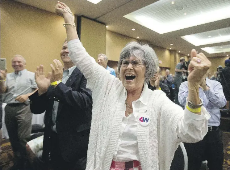  ?? DAVID BLOOM ?? A unity supporter cheers on Saturday in Red Deer after the Wildrose party voted in favour of uniting with the Progressiv­e Conservati­ves.