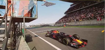  ??  ?? Red Bull’s Daniel Ricciardo passes the checkered flag to win the Chinese Grand Prix in Shanghai on Sunday. REUTERS PIC