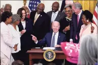  ?? Evan Vucci / Associated Press ?? President Joe Biden points to Opal Lee after signing the Juneteenth National Independen­ce Day Act in the East Room of the White House, Thursday in Washington. From left, Rep. Barbara Lee, D-Calif, Rep. Danny Davis, D-Ill., Opal Lee, Sen. Tina Smith, D-Minn., Vice President Kamala Harris, House Majority Whip James Clyburn of S.C., Sen. Raphael Warnock, D-Ga., Sen. John Cornyn, R-Texas, obscured, Rep. Joyce Beatty, D-Ohio, Sen. Ed Markey, D-Mass., and Rep. Sheila Jackson Lee, D-Texas.