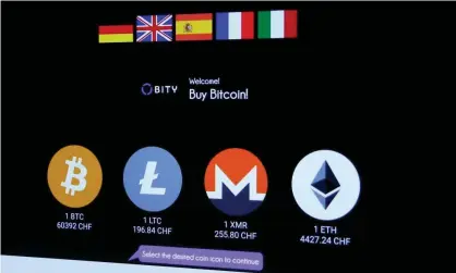  ?? Photograph: Arnd Wiegmann/Reuters ?? Exchange rates in Swiss francs of bitcoin and other cryptocurr­encies Zurich on 4 November.