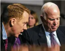  ?? Zach Gibson / New York Times ?? Sen. John McCain, R-Ariz., right, says he will vote in favor of the Senate tax cut bill. “It’s clear this bill’s net effect on our economy would be positive,” he said Thursday.