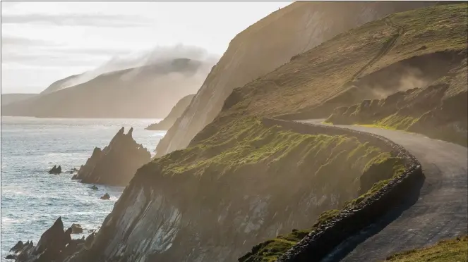  ??  ?? The truly dramatic coastline drive from Dingle on the west coast of Ireland and the joy of lamb hugging, below