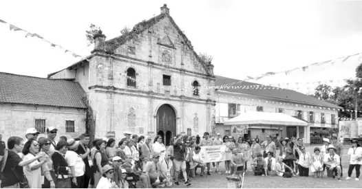  ?? GHIO ONG ?? Delegates of the Winter Escapade tour program pose for a photo in front of the Archdioces­an Shrine of San Miguel Arcangel in Argao, Cebu.