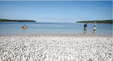  ?? CHELSEY LEWIS / MILWAUKEE JOURNAL SENTINEL ?? Schoolhous­e Beach on Washington Island features smooth, white limestone rocks.