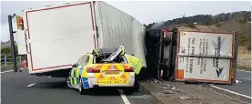  ??  ?? Crushed: A lorry was blown over onto a police car in East Linton