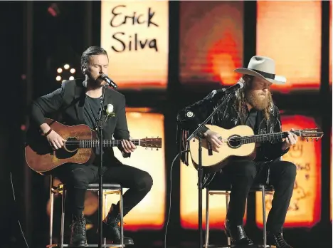  ?? MATT SAYLES/THE ASSOCIATED PRESS ?? The Brothers Osborne don’t shy away from making their personal views known, displaying rare candour in a politicall­y extremist climate. Here, they perform Tears from Heaven at the Grammys, in tribute to those killed in the Las Vegas gun massacre.