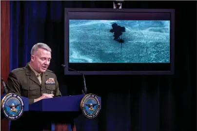  ?? The Associated Press ?? PENTAGON: Video of the Abu Bakr al-Baghdadi raid is displayed as U.S. Central Command Commander Marine Gen. Kenneth McKenzie speaks Wednesday at a joint press briefing at the Pentagon in Washington.