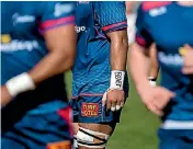  ??  ?? Tasman Makos No 8 Jordan Taufua writes the word ‘‘beast’’ on his wrist tape.