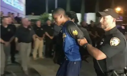  ??  ?? Shooting suspect Darian Tawan Atkinson is led into a police station in Biloxi, Mississipp­i on 6 May. Photograph: AP