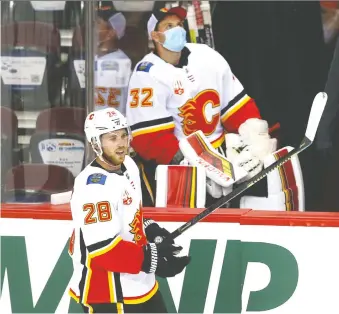  ?? JIM WELLS ?? Elias Lindholm skates in front of goalie Jon Gillies on bench during an intrasquad game at the Saddledome earlier this week. While fans are supportive of the team, the race for the Cup isn’t captivatin­g everyone.