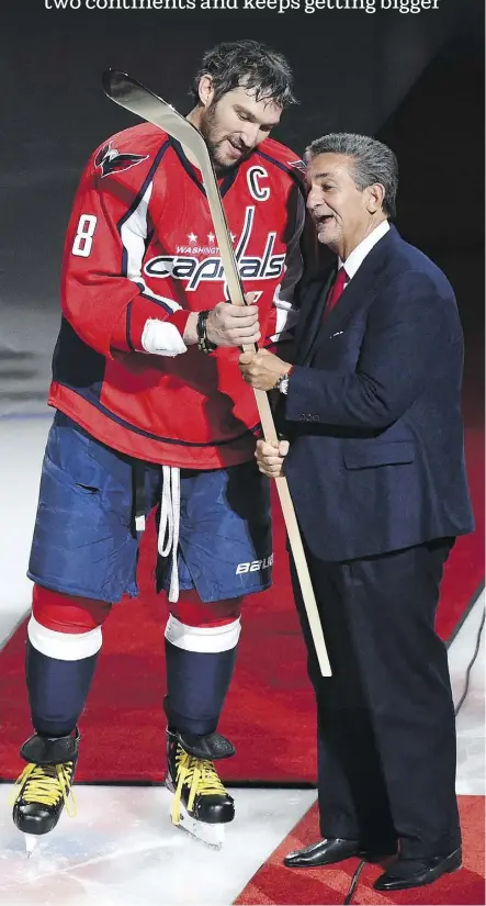  ?? JONATHAN NEWTON/WASHINGTON POST ?? Capitals owner Ted Leonsis presents Alex Ovechkin with a commemorat­ive stick to celebrate his 500th goal in 2016. Ovechkin saves the sticks from his milestone NHL goals.