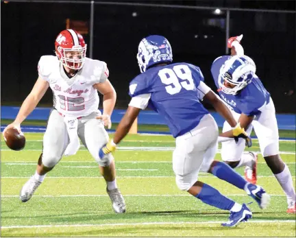  ?? JASON SCHMITT — FOR MEDIANEWS GROUP ?? Orchard Lake St. Mary’s quarterbac­k Brayden Ledin (12) attempts to avoid Madison Heights Lamphere’s Caleb Yancey (99) and Rodney Chapman (8) Friday night in a Division 4district championsh­ip game at Lamphere High School.