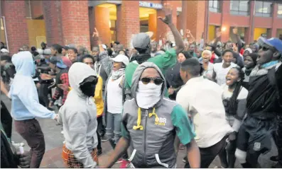  ?? PICTURES: JASON BOUD ?? BEHIND THE MASK: The #UWCfeeswil­lfall group protests at the Chris Hani residence at the university yesterday. The group of about 200 people stormed the administra­tion block and vowed to continue the protest until the university met its demands.