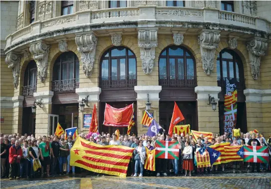  ?? (Reuters) ?? PROTESTERS CARRY Esteladas, Catalan separatist flags and Basque flags, during a rally in in the Basque city of Bilbao in support of the referendum for independen­ce from Spain for the autonomous community of Catalonia.