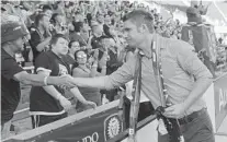  ?? KIM KLEMENT/USA TODAY SPORTS ?? Orlando City SC coach James O’Connor greets fans following a home game against the Columbus Crew. O’Connor is confident he can make offseason changes that will make the Lions more competitiv­e after a dismal season.