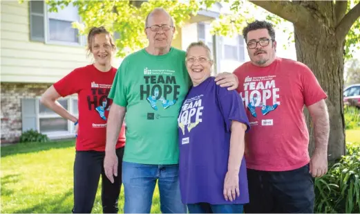  ?? RICH HEIN/SUN-TIMES ?? Dave and Susie Hodgson (center) are photograph­ed with their daughter, Emily, and son, James Leck, outside their Somonauk, Illinois, home.