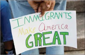  ?? REUTERS ?? A demonstrat­or holds a sign against the Trump administra­tion’s immigratio­n policy, in Manhattan, New York, on 26 July.