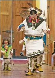  ?? PHOTOS BY JANE PHILLIPS/FOR THE NEW MEXICAN ?? RIGHT: Darryl Montoya of Ohkay Owingeh and his son, Daniel White-Montoya, 2, lead the Bow and Arrow Dance that concluded the Fiesta Mass.