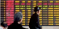  ?? — Reuters ?? Investors look at an electronic screen at a brokerage house in Shanghai on Monday. Chinese shares were nearly flat as investors locked in profits after last week’s announceme­nt that Hong Kong and China investors will be able to buy shares in companies listed on each other’s bourses.