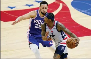  ?? MATT SLOCUM — THE ASSOCIATED PRESS ?? Washington‘s’ Bradley Beal, right, tries to get past the Sixers’ Ben Simmons during the second half Wednesday night.