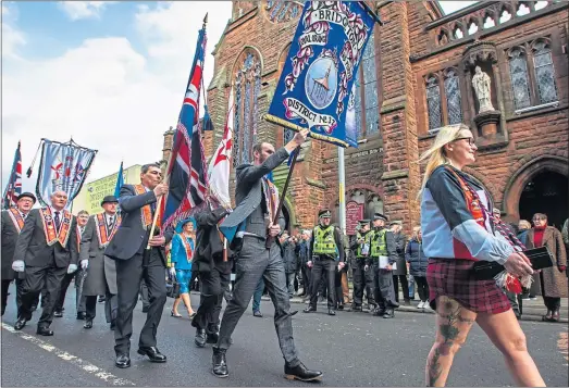  ??  ?? Police on site as the march passes the churchPict­ure: