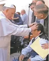  ?? AP ?? Pope Francis lays his hands on a young man’s head after celebratin­g Mass in St. Peter’s Square in 2013.