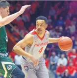  ??  ?? UNM’s Elijah Brown (4) drives around Colorado State’s Nico Carvacho during Tuesday night’s game.