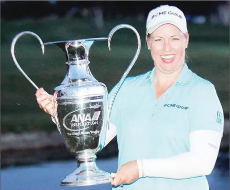  ??  ?? Brittany Lincicome holds up the trophy after winning the LPGA Tour ANA Inspiratio­n golf tournament in the third playoff round at Mission Hills Country Club in
Rancho Mirage, California, on April 5. (AP)