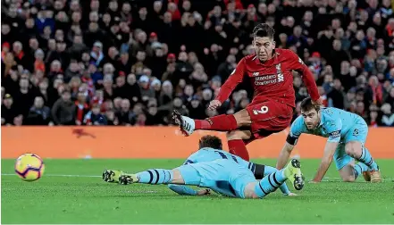  ??  ?? Liverpool’s Roberto Firmino scores his side’s second goal of the game against Arsenal, during their English Premier League match.