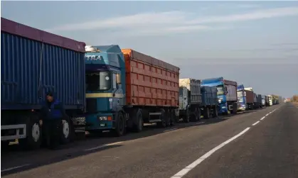  ?? Photograph: Carl Court/Getty ?? Grain trucks queue on the roadside near a port in Odesa. Morocco and Turkey were the largest purchasers of fertiliser­s from Ukraine in 2021.