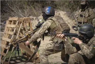  ?? EFREM LUKATSKY — THE ASSOCIATED PRESS ?? Members of the Siberian Battalion, which was formed mostly of volunteer Russian citizens, of the Ukrainian Armed Forces’ Internatio­nal Legion, practice during military exercises, amid Russia’s attack on Ukraine, at an undisclose­d location in Kyiv region, Ukraine, Wednesday.