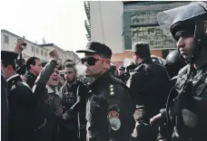  ?? AP ?? Coptic Christians protest as police stand guard on a street after a funeral for victims of the 2016 cathedral attack in Cairo