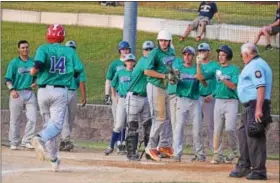  ?? PHOTOS BY AUSTIN HERTZOG — DIGITAL FIRST MEDIA ?? Tyler Hibbs (14) is congratula­ted by his Spartans teammates after hitting a three-run home run against Pine Forge Monday.