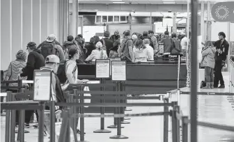  ?? Steve Gonzales / Staff photograph­er ?? Travelers make their way through Terminal A security at Bush Interconti­nental Airport in Houston. The Terminal B checkpoint closed at IAH due to low staffing during the shutdown.