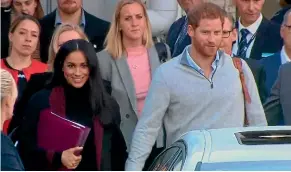  ?? FAIRFAX ?? Prince Harry and Meghan head for their car after flying into Sydney airport yesterday.