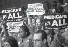  ??  ?? Supporters of Sanders hold signs during an event on health care on Capitol Hill in Washington, DC. — Reuters photo