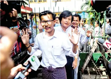  ??  ?? Detained Myanmar journalist­s Kyaw Zaw Lin (left) followed by Nayi Min (centre) and Phyo Wai Win (right) leave the court compound after a hearing in Yangon. — AFP photo