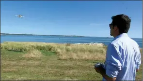  ?? AP/RODRIQUE NGOWI ?? Aerospace engineer Felipe Bohorquez guides a test drone taking a UPS delivery to Children’s Island in Marblehead, Mass., last week.