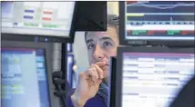  ?? RICHARD DREW / AP ?? Specialist Anthony Rinaldi works on the floor of the New York Stock Exchange. Wall Street’s success has helped Americans’ net worth to rise 1.8 percent in the April-June quarter.