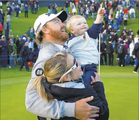  ?? Patrick T. Fallon For The Times ?? J.B. HOLMES is joined by his wife Erica and son Tucker after clinching the Genesis Open title Sunday. It was the fifth victory of his career and first since April of 2015 for the 36-year-old Holmes, who outlasted fellow Kentuckian Justin Thomas in the final round.