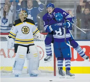  ?? FRANK GUNN/ THE CANADIAN PRESS ?? Toronto Maple Leafs defenceman Dion Phaneuf celebrates with teammate Phil Kessel after scoring on Boston Bruins goalie Tuuka Rask during third- period first- round NHL playoff action in Toronto.